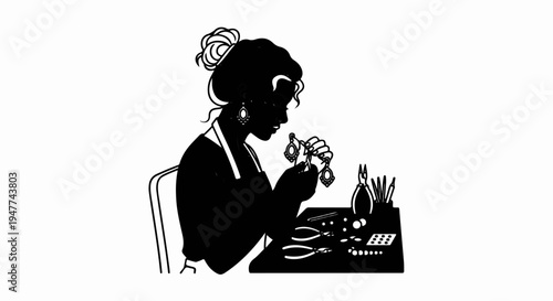 Silhouette of a woman crafting intricate jewelry at her workbench