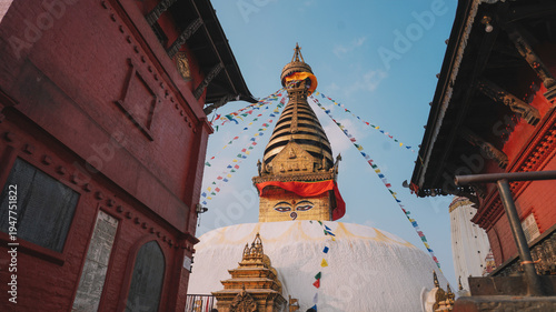 Ancient Buddhist Stupa with Golden Spire and Colorful Prayer Flags