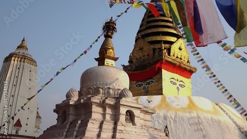 Ancient Buddhist Stupa with Golden Spire and Colorful Prayer Flags