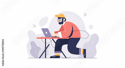 Man wearing glasses and a cap works on a laptop at a table