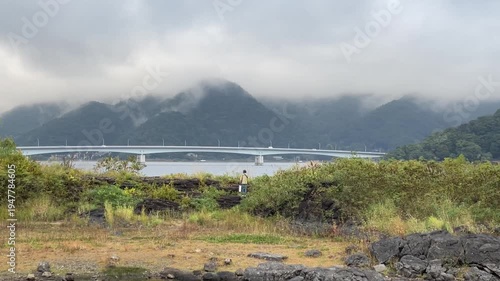 Scenic View of Kawaguchiko Ohashi Bridge with Misty Mountains and Lake Kawaguchi in Japan