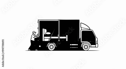 Worker loading furniture into a moving truck