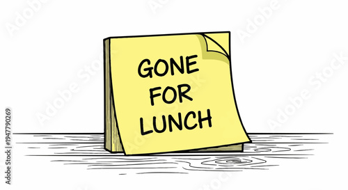 Yellow sticky note with "GONE FOR LUNCH" text on a wooden surface