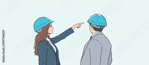 Two workers are talking at a construction site. One is pointing to something while wearing a helmet. They focus on their work.