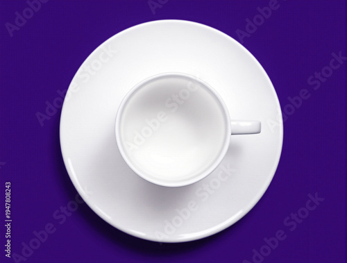 flat lay Top view of an empty white espresso cup with a saucer against a dark purple background