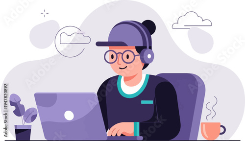 Person wearing headphones and cap working on laptop with hot drink nearby