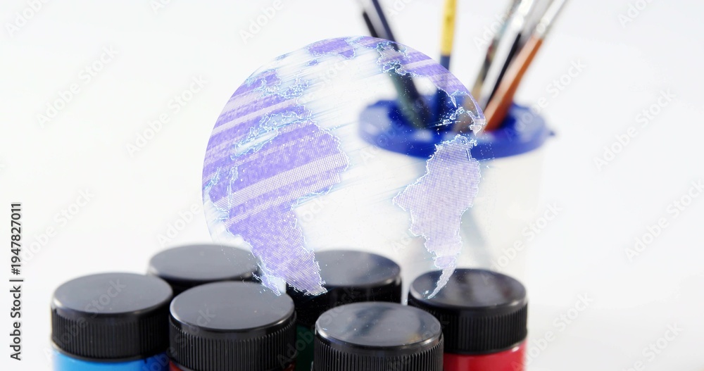 Fototapeta premium Showing six paint jars blackcap on art table, holo globe floating above blue-rim holder and brushes