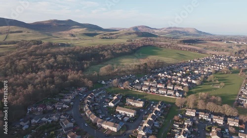 Aerial view of Penicuik town with the majestic Carnethy Hill in the background: Scenic drone flight over Midlothian countryside towards the Pentland Hills