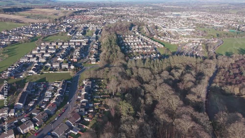 A scenic drone perspective of Penicuik townscape: A wide view of a Scottish residential settlement surrounded by green hills and fields