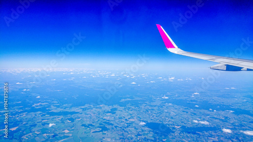 Aftersunset sky, bright blue, dotted with soft white clouds