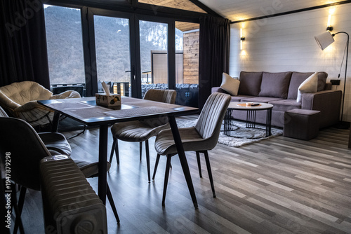 Canvastavla Cozy living room interior in mountain guest house with sofa, armchairs and coffee table