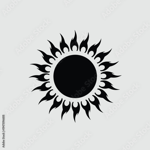 Black tribal sun symbol with flame like rays on a light gray background