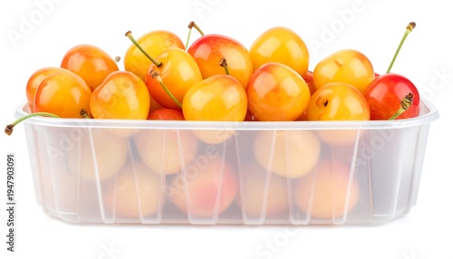 A close-up shot of a plastic container overflowing with golden-yellow cherries. Some have a blush of red, stems attached