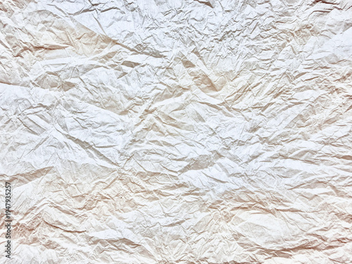 crumpled white paper texture showcases deep organic creases and soft neutral shadows in hyper detailed abstract macro