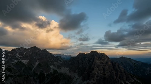 Scenic mountain range under dramatic clouds at dusk with a beautiful sky