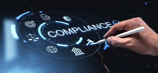 Compliance digital interface with glowing regulatory icons and a hand using a stylus on a futuristic blue background illustrating governance concept.
