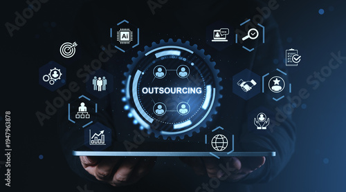 Photos Digital outsourcing interface with multiple futuristic glowing icons and modern digital technology elements over dark background