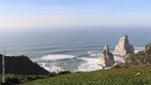 Atlantic ocean waves crashing against ursa and giant rocks at cabo da roca