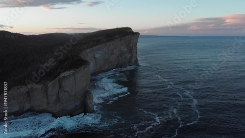 Aerial drone view of dramatic Cap Gaspé cliffs at dusk, Forillon National Park Quebec Canada