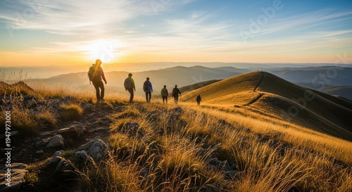 Hikers watching sunset on a mountain peak with a group