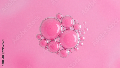 Transparent pink hyaluronic acid serum bubbles on a soft pastel background — 3D macro cosmetic texture. Abstract pink collagen molecule structure with glossy spheres — Biotechnology and skin cell 
