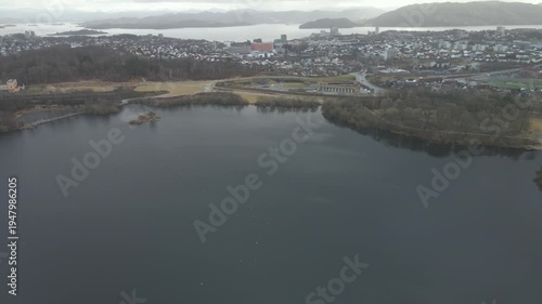 Wallpaper Mural Aerial drone footage showing a lake under moody weather conditions. The scene features calm water, subdued lighting, and overcast skies, presenting a quiet natural landscape with minimal movement and  Torontodigital.ca