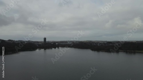 Wallpaper Mural Aerial drone footage showing a lake under moody weather conditions. The scene features calm water, subdued lighting, and overcast skies, presenting a quiet natural landscape with minimal movement and  Torontodigital.ca