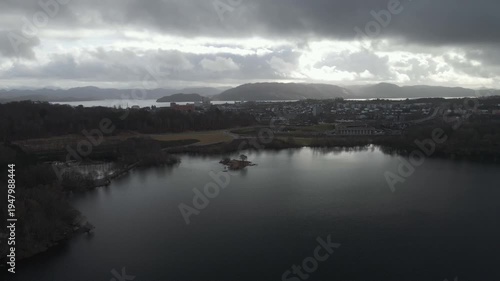 Wallpaper Mural Aerial drone footage showing a lake under moody weather conditions. The scene features calm water, subdued lighting, and overcast skies, presenting a quiet natural landscape with minimal movement and  Torontodigital.ca