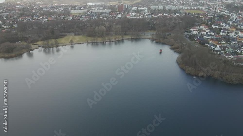 Wallpaper Mural Aerial drone footage showing a lake under moody weather conditions. The scene features calm water, subdued lighting, and overcast skies, presenting a quiet natural landscape with minimal movement and  Torontodigital.ca