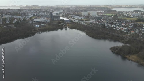 Wallpaper Mural Aerial drone footage showing a lake under moody weather conditions. The scene features calm water, subdued lighting, and overcast skies, presenting a quiet natural landscape with minimal movement and  Torontodigital.ca