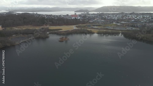 Wallpaper Mural Aerial drone footage showing a lake under moody weather conditions. The scene features calm water, subdued lighting, and overcast skies, presenting a quiet natural landscape with minimal movement and  Torontodigital.ca