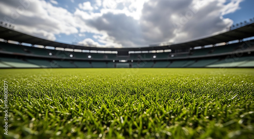 Wide angle view of a lush green soccer field and stadium seating under a cloudy sky with sports field