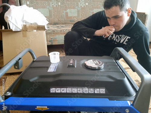 Man checks generator setup in home living room during daytime