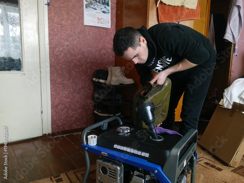 Man fills a generator with fuel in his home during the day