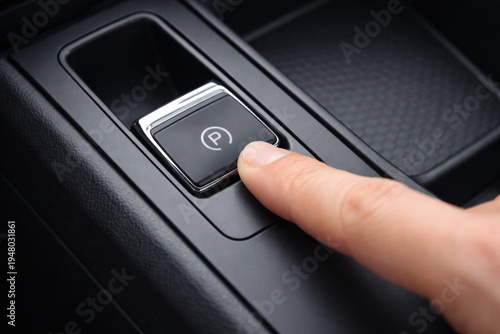 Wallpaper Mural Finger pressing electronic parking brake button in modern car interior. Ai generative Torontodigital.ca