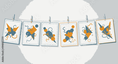 Modern abstract illustrations displayed on a drying line with clothespins