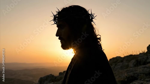 Profile silhouette of Jesus Christ wearing a crown of thorns at sunset. Man representing savior praying in rocky landscape. Biblical religious scene of faith.