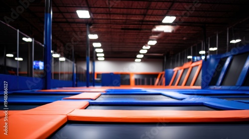 A vibrant indoor trampoline park featuring colorful trampolines and open space for jumping