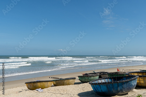Colorful Round Fishing Boats on My Khe Beach with Blue Sky and Waves
