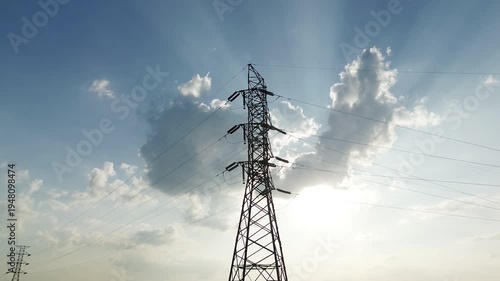 Aerial drone footage of high voltage transmission towers and power lines during perfect natural light afternoon with dynamic movement and diverse angles for energy infrastructure visuals.