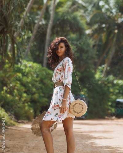 Young Woman in Floral Summer Dress Walking on Tropical Beach Path