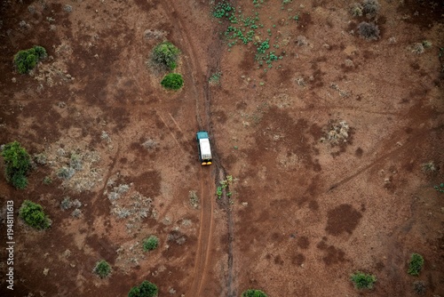 aerial view on a safari vehicle in the sparse savannah of the Amboseli National park in Kenya