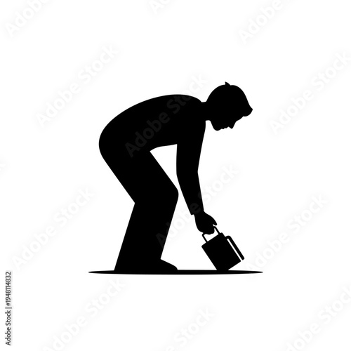A person bending down to pick up a small object from the ground.