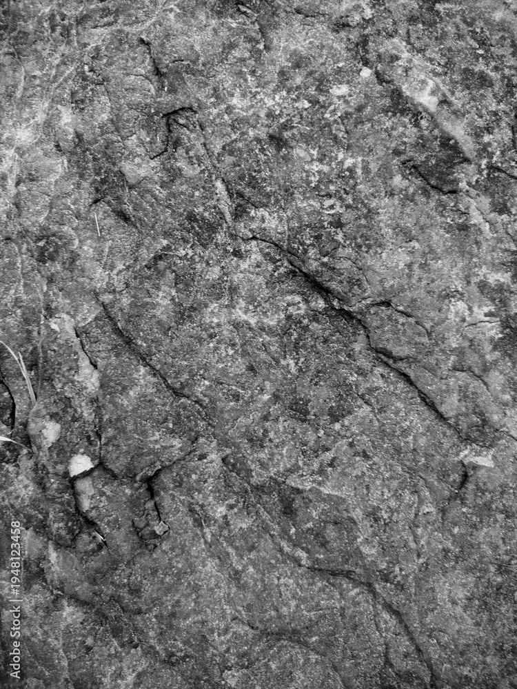 Naklejka premium Grey Dark rough rock texture with natural stone patterns and gritty surface details for backgrounds 
