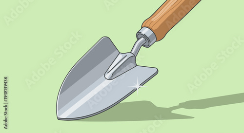 Clean garden trowel with wooden handle on a green background.