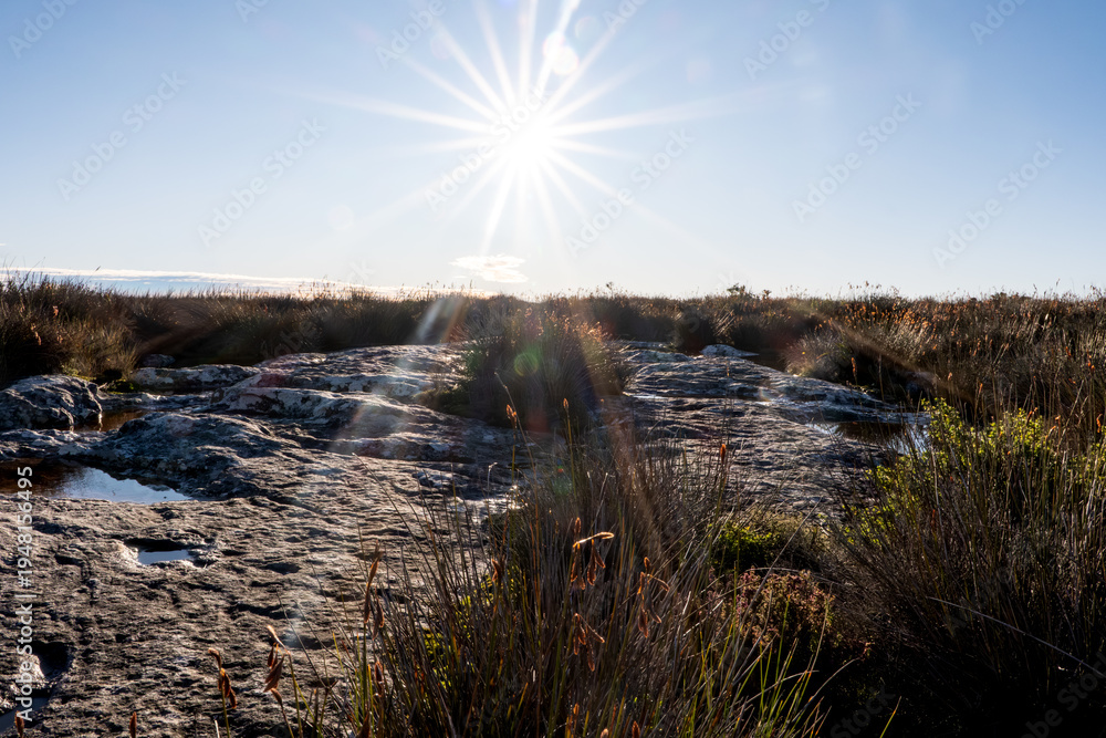 Fototapeta premium Sunburst Over Rock Pools on Table Mountain Plateau, Cape Town South Africa