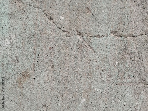 Close up of cracked concrete surface with rough texture and small imperfections image photo