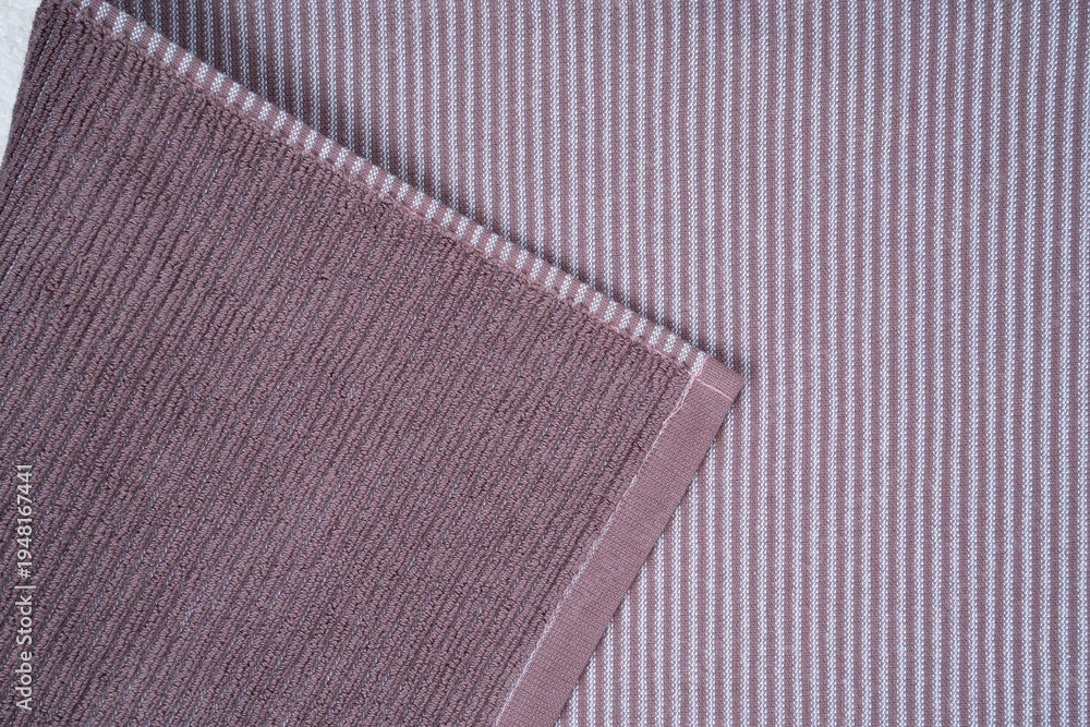 Fototapeta premium multicolored terry towels, rolled up and stacked on the table