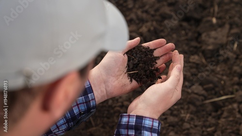 Tableau sur toile Fertile soil in male hands of farmer