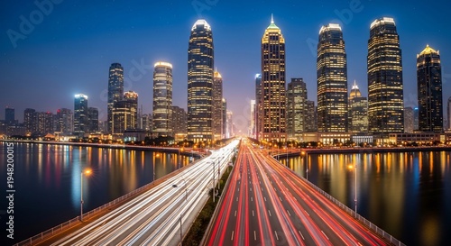 Stunning Night View of Shanghai Cityscape with Illuminated Skyscrapers and Streaks of Light from Moving Traffic.